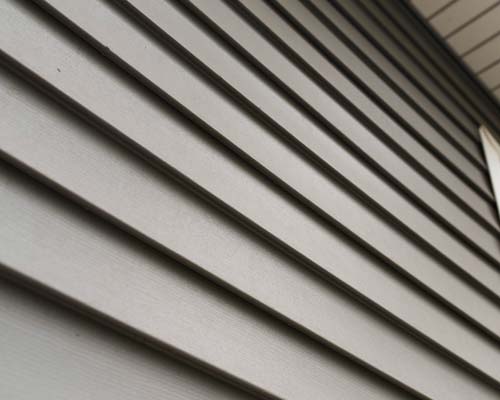 Close-up of gray vinyl siding panels with clean horizontal lines